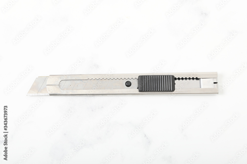 Typical stainless steel office paper cutter. Box cutter. Typical stainless steel office paper cutter. Box cutter.