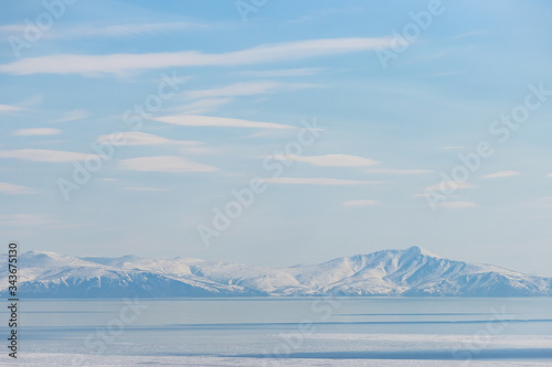 Landscape with sea bay, mountains and clouds in the sky. Gertner Bay, Sea of ​​Okhotsk. Magadan Region, Siberia, Far East of Russia. Great for background. © Andrei Stepanov