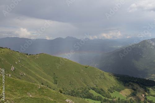Rainbow over mountains in a sunny day.