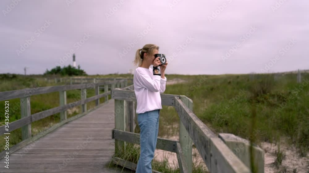 Slow motion, happy smiling hipster girl enjoying from spending leisure time for photo hobby during spring vacations on nature, positive young Caucasian woman taking images on instant camera outdoors
Slow motion, happy smiling hipster girl enjoying from spending leisure time for photo hobby during spring vacations on nature, positive young Caucasian woman taking images on instant camera outdoors
