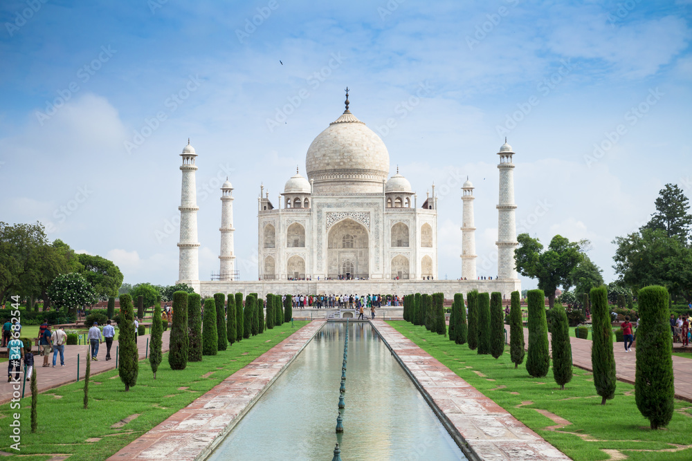 Fototapeta premium The view of symmetry Taj Mahal and reflection on central axis pool