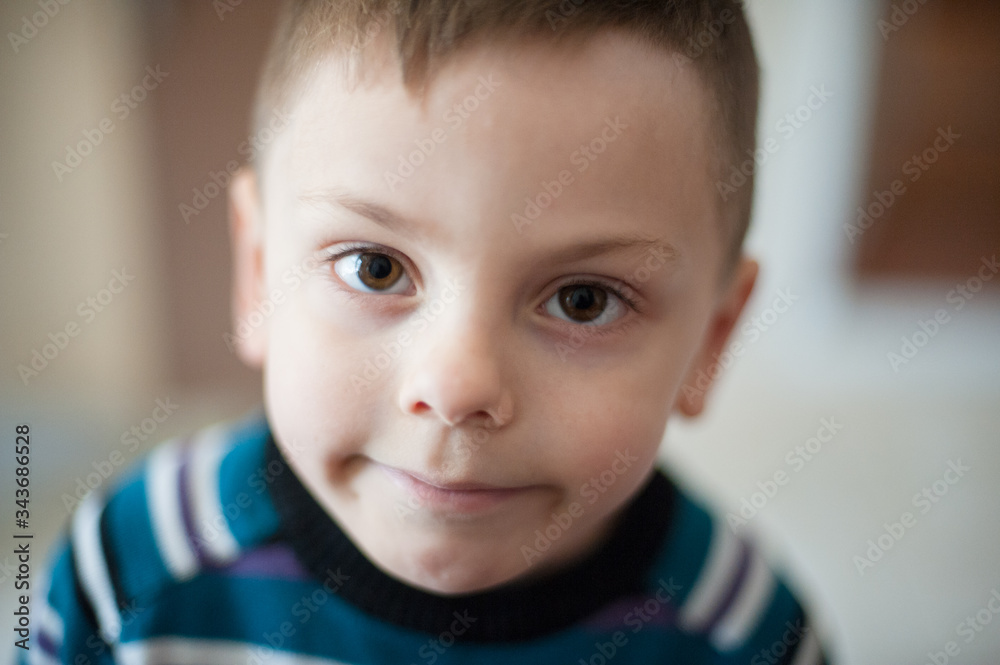 emotion mental confusion smile on little caucasian child in sweater during self isolation