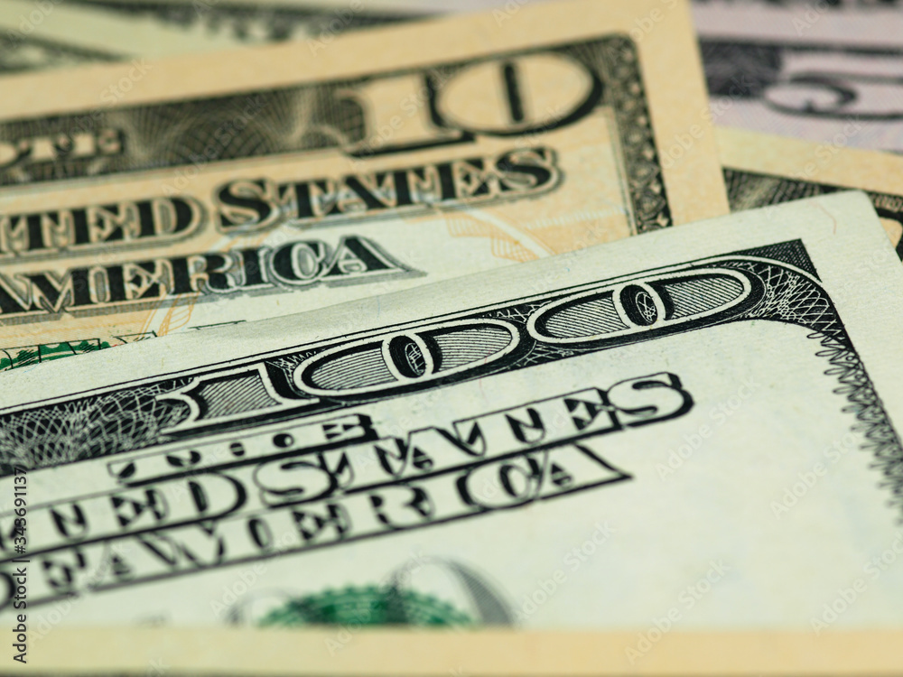 Colorful background with money US dollars of different value. Top view of business concept with finance for banks. American banknotes 5, 10, 50, 100 dollars backdrop Colorful background with money US dollars of different value. Top view of business concept with finance for banks. American banknotes 5, 10, 50, 100 dollars backdrop