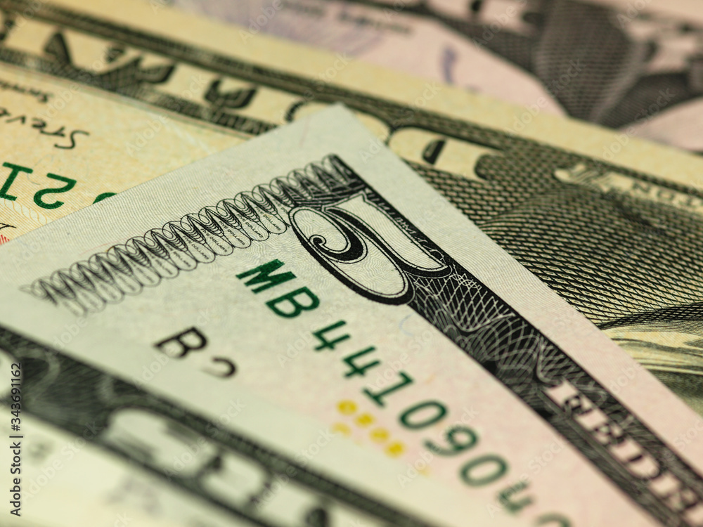 Colorful background with money US dollars of different value. Top view of business concept with finance for banks. American banknotes 5, 10, 50, 100 dollars backdrop Colorful background with money US dollars of different value. Top view of business concept with finance for banks. American banknotes 5, 10, 50, 100 dollars backdrop