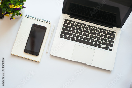 Minimalistic workspace. Creative flat lay desktop office desk with laptop and notepad. Top view with copy space, flat lay photography