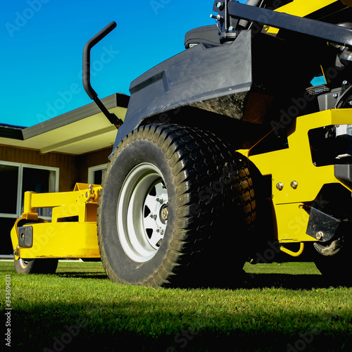 Lawn mower park in green grass field, zero turn Lawn mower.
