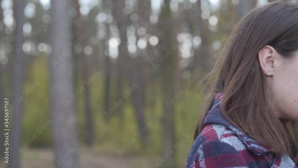 Pretty brunette girl looking at camera and leaving. Portrait of confident young Caucasian woman in sunny forest. Leisure, nature, lifestyle, confidence. Pretty brunette girl looking at camera and leaving. Portrait of confident young Caucasian woman in sunny forest. Leisure, nature, lifestyle, confidence.
