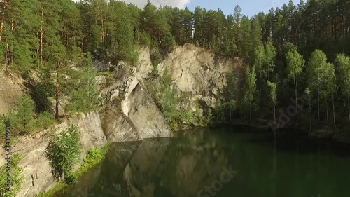 Small lake and talc rock in the forest. Aerial. Talkc stone in Sysert city. Sverdlovsk region, Russia photo