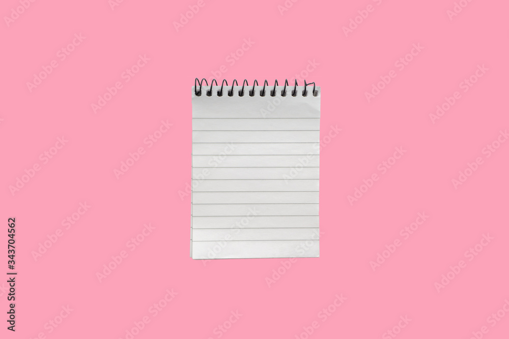Notepad or notebook on pink background. Business and copy space concept Notepad or notebook on pink background. Business and copy space concept