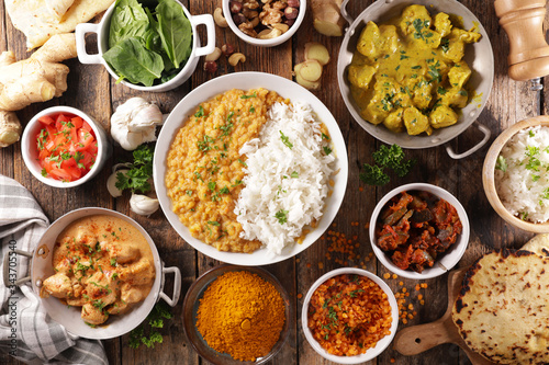 assorted of indian food- chicken tikka masala, curry lentil dal, naan bread