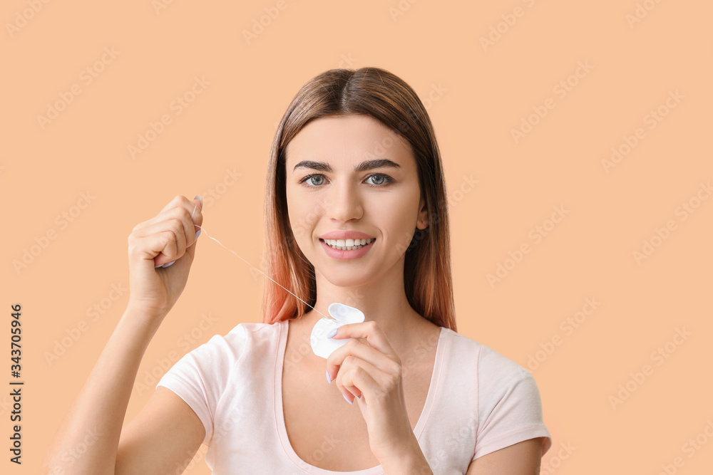 Beautiful young woman with dental floss on color background Beautiful young woman with dental floss on color background