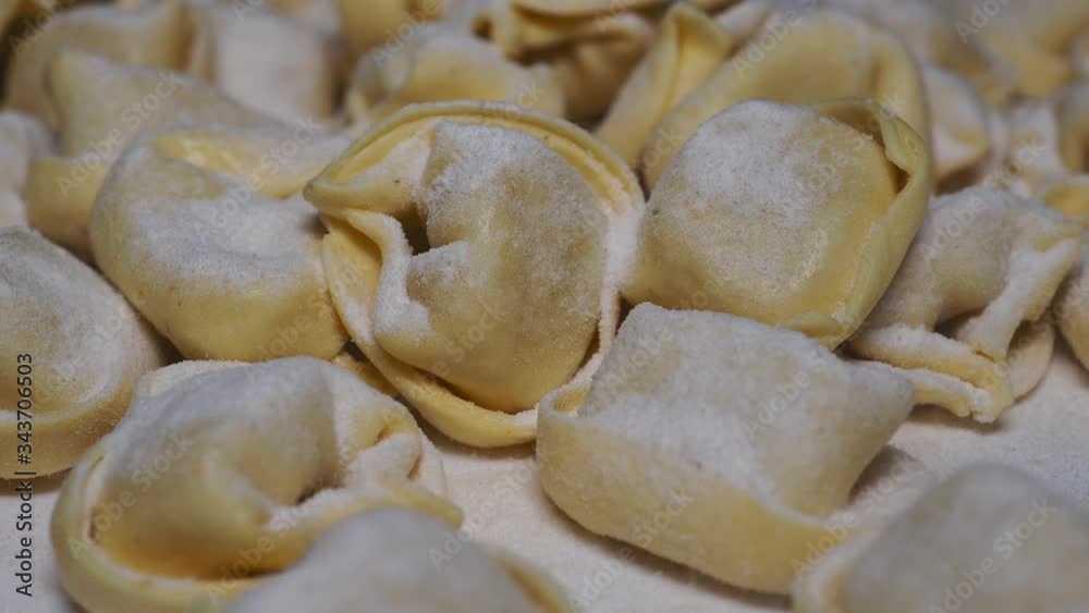 Delicious tortellini a ring-shaped pasta from Italy. Traditionally they are stuffed with a mix of meat, parmigiano reggiano cheese, egg and nutmeg Delicious tortellini a ring-shaped pasta from Italy. Traditionally they are stuffed with a mix of meat, parmigiano reggiano cheese, egg and nutmeg