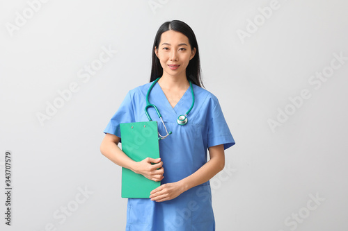 Female Asian doctor with cl...