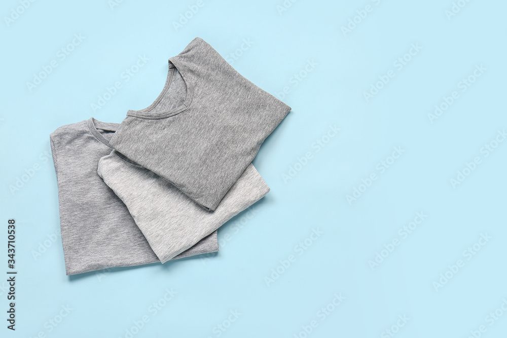 Stylish t-shirts on color background Stylish t-shirts on color background