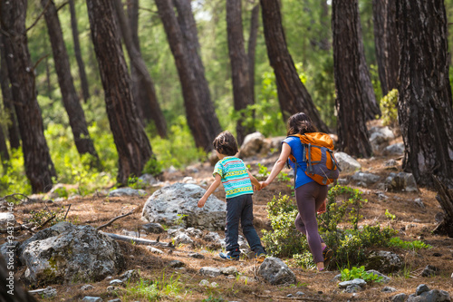 A child with his mother go hiking.