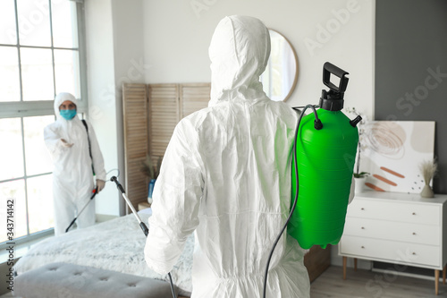 Workers in biohazard suits ...