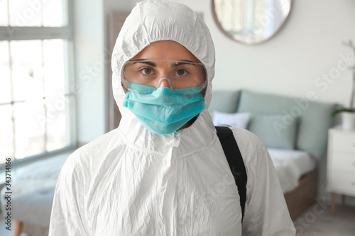 Worker in biohazard suit di...