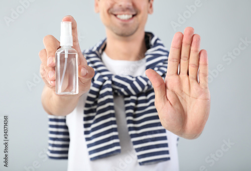 Man with disinfectant on gr...