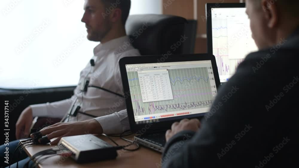 I wasn't be there. Suspicious man passes lie detector in the office. Asking questions. Polygraph test.