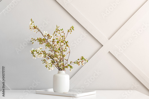 Fototapeta Naklejka Na Ścianę i Meble -  Vase with beautiful blooming branches on table