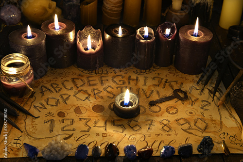Slika na platnu Talking spiritual board with black candles and old key.