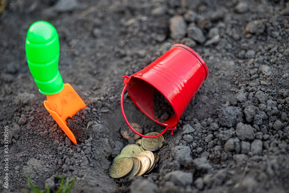 shovel and bucket of coins on ground. Earnings in agribusiness. way to make money in rural farm. Income in times of crisis. shovel and bucket of coins on ground. Earnings in agribusiness. way to make money in rural farm. Income in times of crisis.
