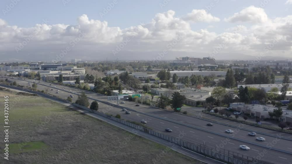 Aerial drone view of traffic along highway and downtown cityscape on cloudy day Aerial drone view of traffic along highway and downtown cityscape on cloudy day