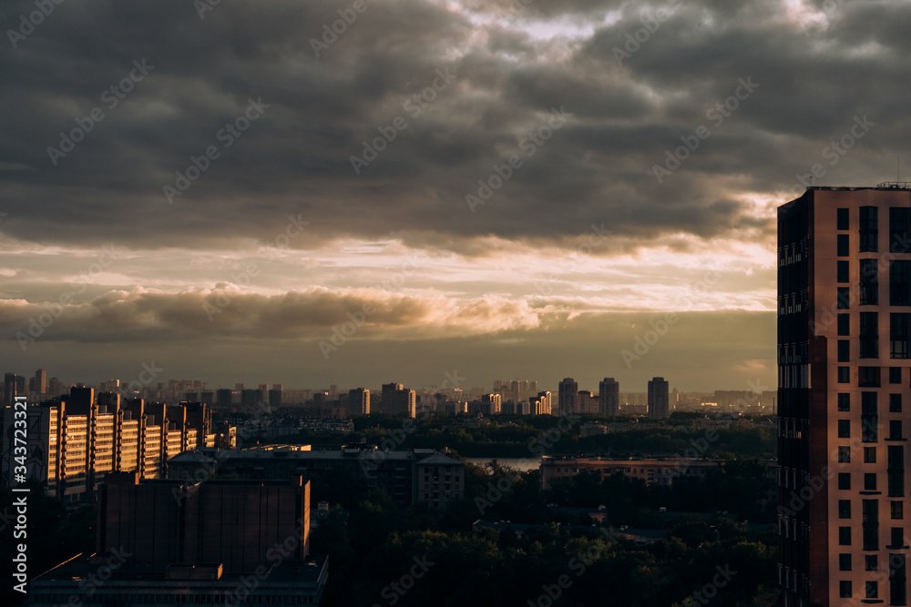 Naklejka premium Moscow. Top view. Stormy sky with clouds and orange gaps. Big city. Industrial. View of ordinary houses in Moscow, a big city
