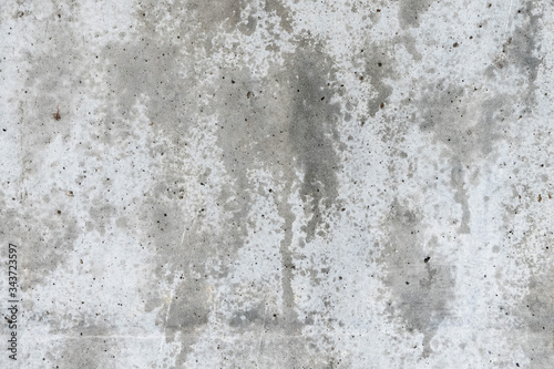 Gray concrete wall with wet spots. The background of the gray wall. © Elena