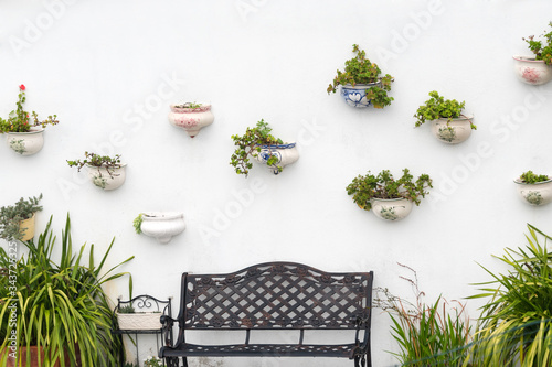 Cuadro en lienzo Typical white village with flower pots on facades at Spain