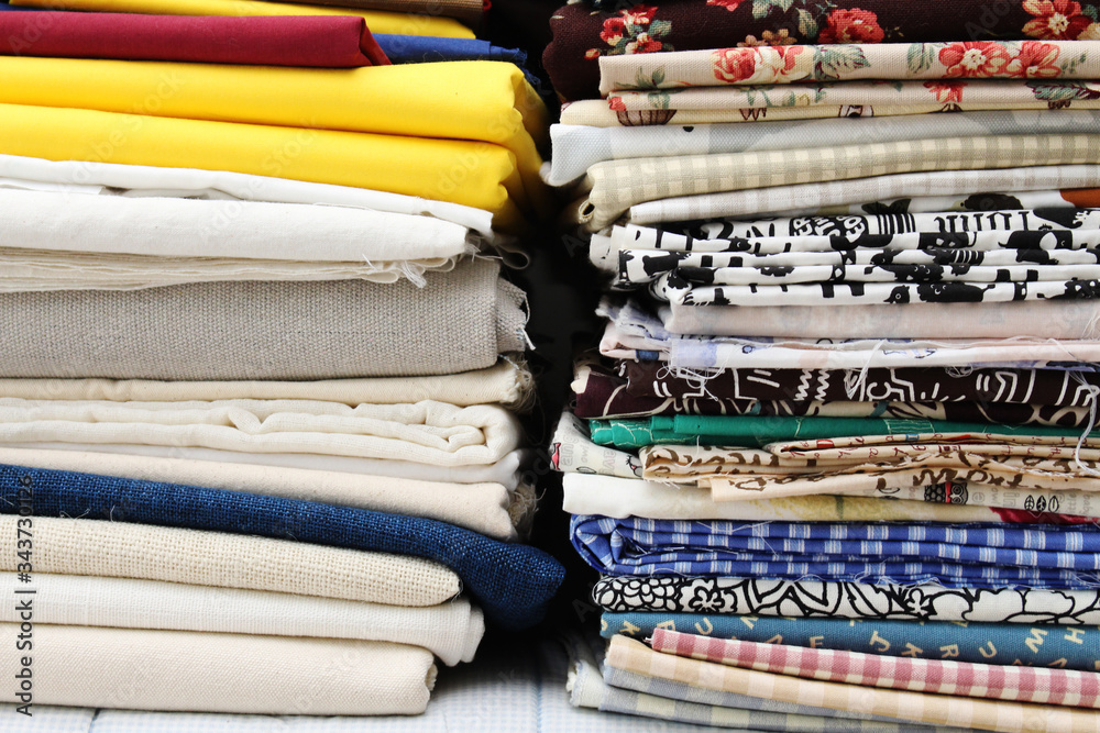 A pile of cloth in various pattern and color