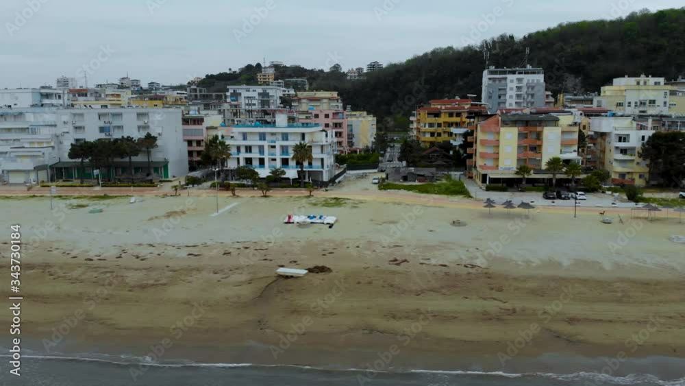 Holiday resorts on seaside of Durres Albania in front of sandy beach washed by Adriatic sea waves on a cloudy spring day Holiday resorts on seaside of Durres Albania in front of sandy beach washed by Adriatic sea waves on a cloudy spring day
