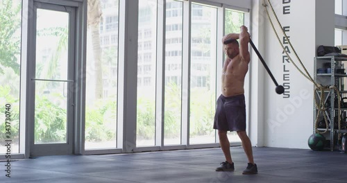 Strong man doing steel mace training