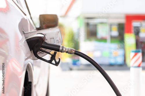 Close-up hands refueling in car,The petrol station staff is refilling the car for customers,Refill fuel in car at gas station,Focus hands refilling.