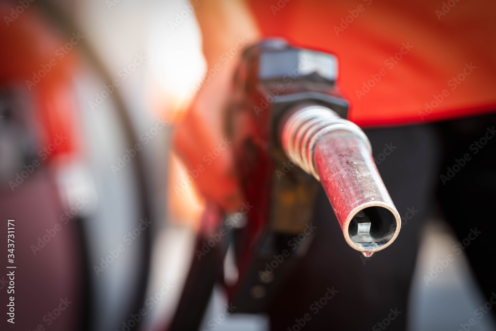 Fototapeta premium Close-up hands refueling in car,The petrol station staff is refilling the car for customers,Refill fuel in car at gas station,Focus hands refilling.