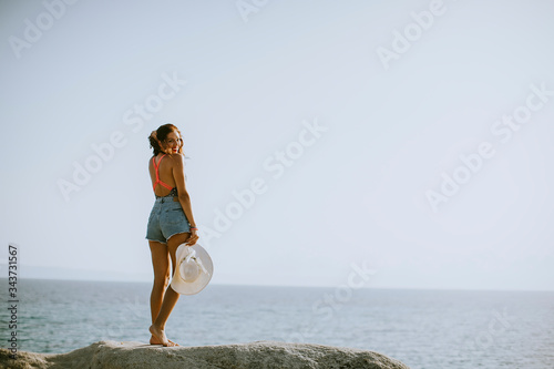Young woman in bikini stand...