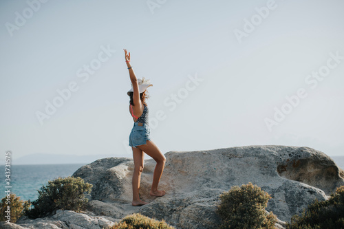 Young woman in bikini walki...