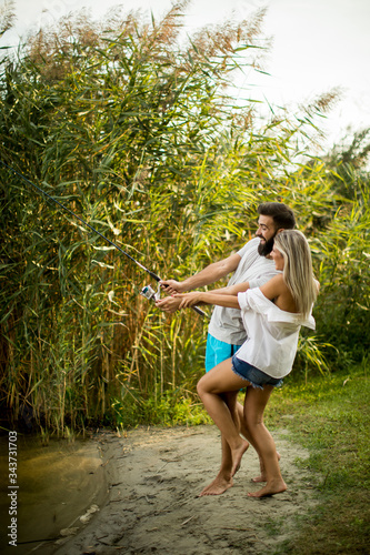 Young couple enjoying fishi...