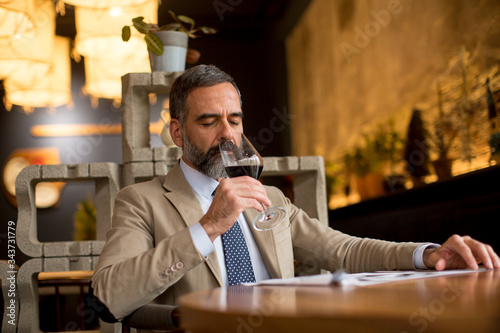 Handsome mature man drinkin...