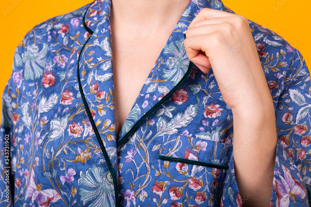 Close up of woman in home wear pajama studio lifestyle yellow background.