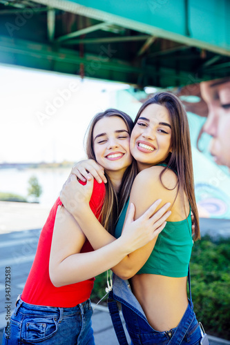 Two best female friends embracing together © BGStock72
