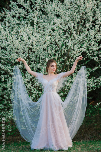 Young beautiful woman in blooming garden. Bride. © Ivan Zelenin