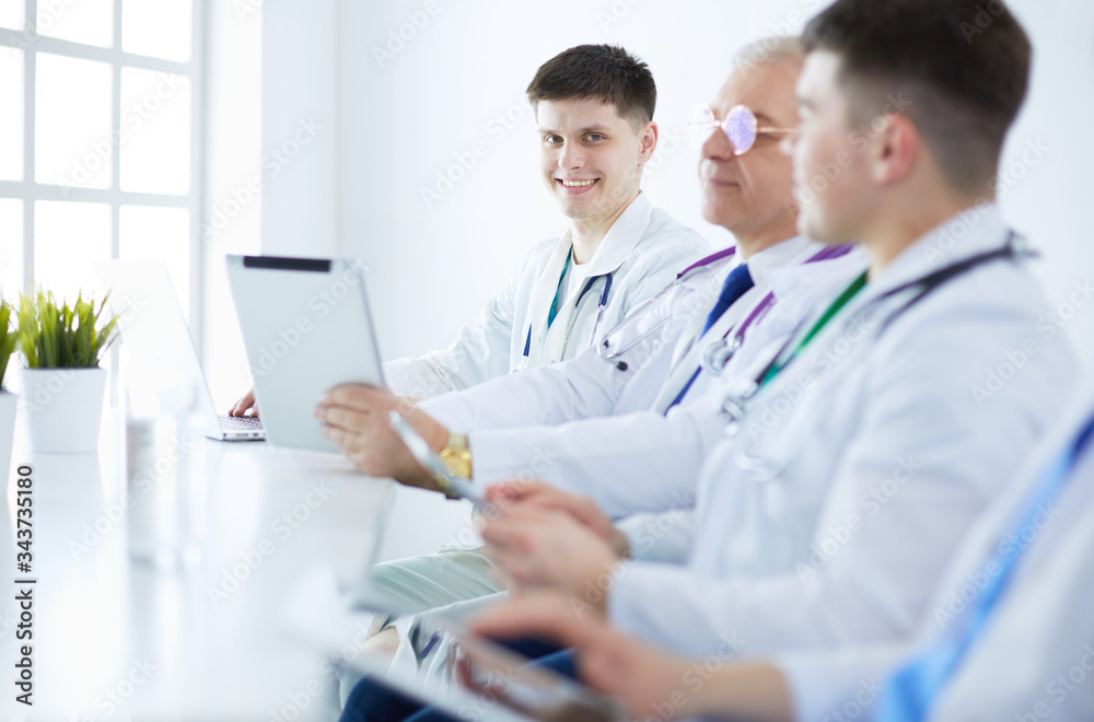 Medical team sitting and discussing at table Medical team sitting and discussing at table