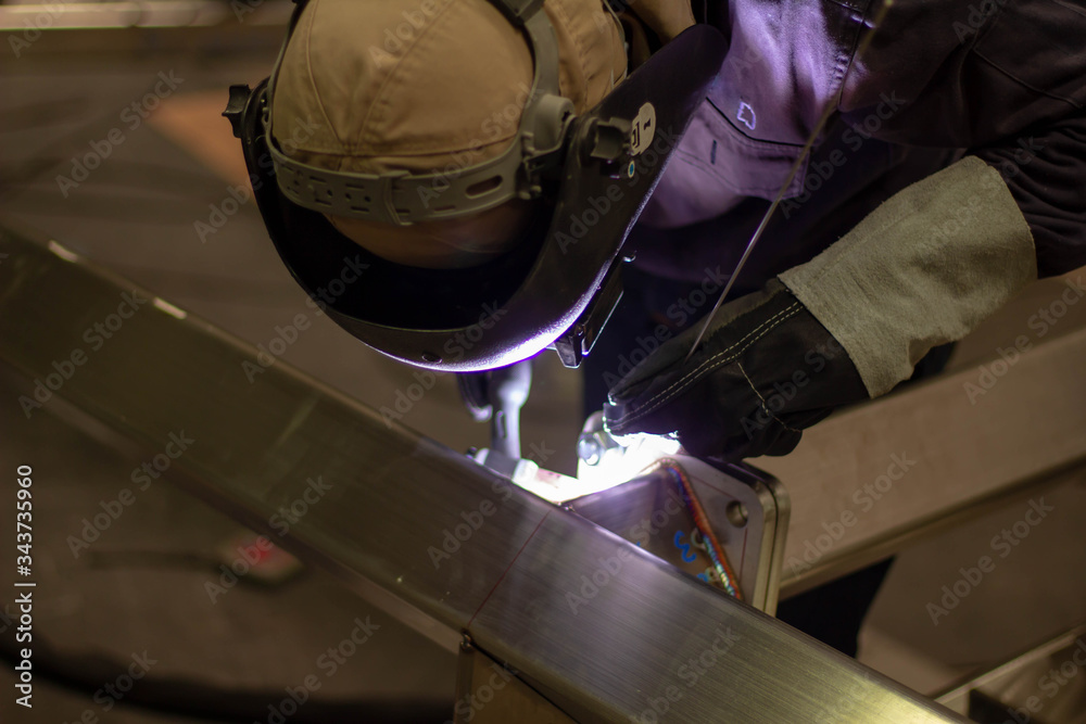 welder working on a construction site. Metal workers use manual labor. Skilled welder. Factory workers making OT. Welder is welding the steel in the factory. welder Industrial automotive part in facto welder working on a construction site. Metal workers use manual labor. Skilled welder. Factory workers making OT. Welder is welding the steel in the factory. welder Industrial automotive part in facto