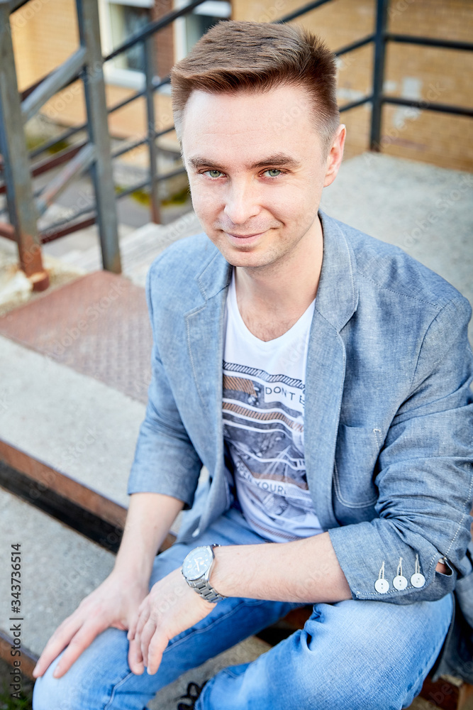 Kirov, Russia - September 04, 2019: Portrait of a handsome fun man outdoors in the city Kirov, Russia - September 04, 2019: Portrait of a handsome fun man outdoors in the city