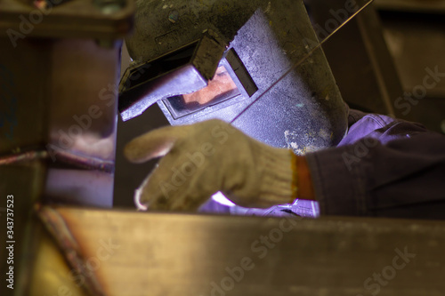 Metal workers use manual labor. Skilled welder. Factory workers making OT. Welder is welding the steel in the factory. welder Industrial automotive part in factory
