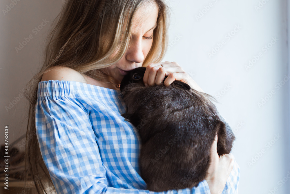 Pet and Easter concept - Attractive girl hugging brown rabbit at home, close-up. Pet and Easter concept - Attractive girl hugging brown rabbit at home, close-up.