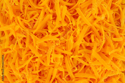 Tableau sur toile Grated cheddar cheese background texture