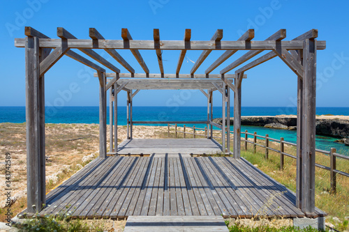 Fototapeta Naklejka Na Ścianę i Meble -  wooden arbor on a wild beach