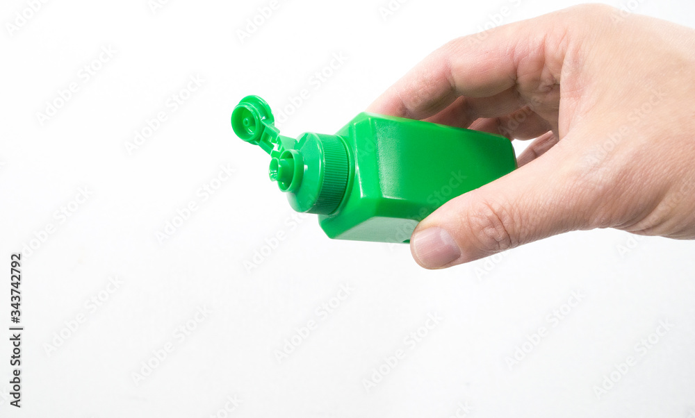 Hand treatment and disinfection. A man's hand holds a dispenser for antibacterial hand treatment. Copy space. Hand treatment and disinfection. A man's hand holds a dispenser for antibacterial hand treatment. Copy space.
